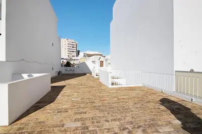 a white bathroom with a shower and a toilet at Casa Vermelha ii in Faro