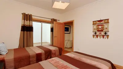 a room with two beds and a window at Villa Terraços da Vinha 230 - Clever Details in Vilamoura