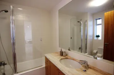 a bathroom with a sink and a shower at Lago Azul Apartment II in Quarteira
