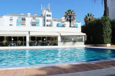 a swimming pool in front of a building at Lago Azul Apartment II in Quarteira