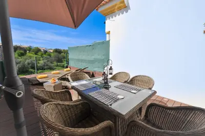 a bedroom with a large white bed with towels on it at Albufeira Townhouses by OCvillas in Albufeira