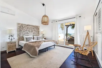 a living room with a bed and a table and chairs at Villa Eva by OCvillas in Albufeira