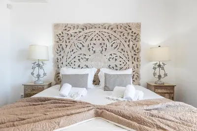 a bedroom with a large bed with two lamps at Villa Eva by OCvillas in Albufeira