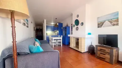 a living room with a couch and a television at Albufeira Balaia Mar e Sol in Albufeira