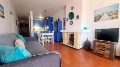 a living room with a couch and a tv at Albufeira Balaia Mar e Sol in Albufeira