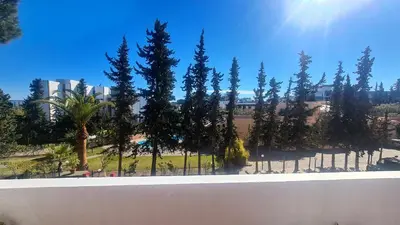 a view of a park with trees and a fence at Albufeira Balaia Mar e Sol in Albufeira