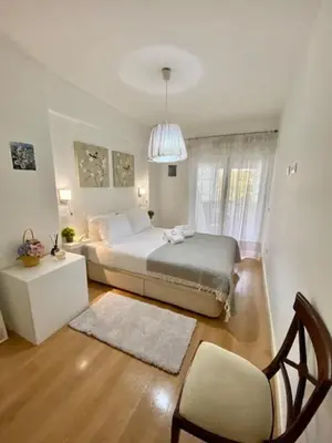 a bedroom with a bed and a chair in it at Cosy Avenida Apartment in Faro