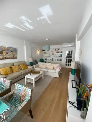 a living room with a couch and a table at Cosy Avenida Apartment in Faro