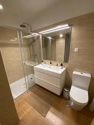 a bathroom with a toilet and a sink and a shower at Cosy Avenida Apartment in Faro