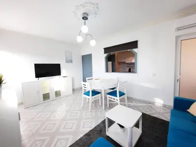 a white living room with a table and chairs at Casa Oceano 1Bedroom apartment W/sea view in Quarteira