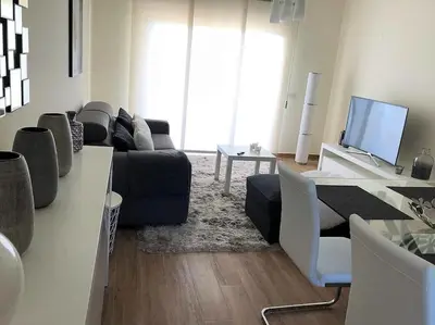 a living room with a couch and a tv at MARINA BLEU Magnifique Appartement Standing vue Piscine in Albufeira
