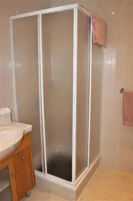 a shower with a glass door in a bathroom at Casa Jacqueline in Albufeira