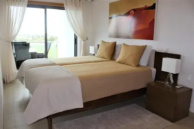 a bedroom with a large bed with a large window at Casa Jaffa in Albufeira