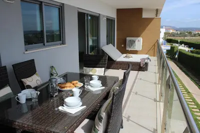 a table with a plate of food on a balcony at Casa Jaffa in Albufeira