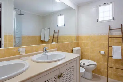 a bathroom with a sink and a toilet at Gorgeous 2BDR Apartment W/Patio & Pool by LovelyStay in Vilamoura