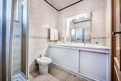 a bathroom with a sink and a toilet and a shower at Villa Oceano in Patroves