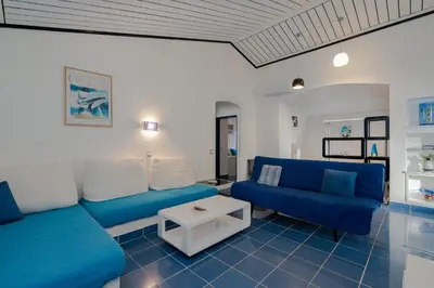 a living room with a blue couch and a table at Villa Vitry by Intiholidays in Albufeira