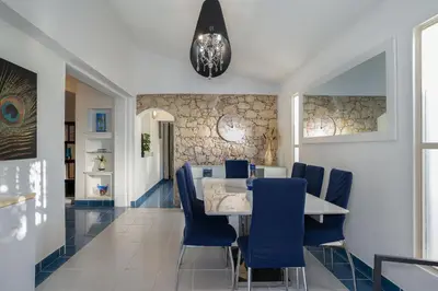 a dining room with a table and blue chairs at Villa Vitry by Intiholidays in Albufeira