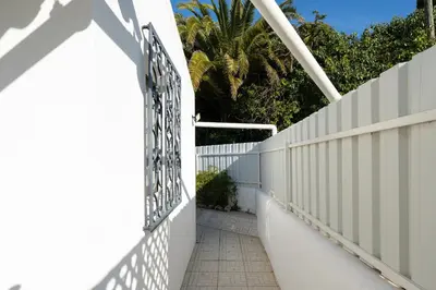 a white fence with a gate and a sidewalk at Villa Vitry by Intiholidays in Albufeira