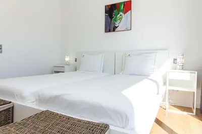 a white bedroom with a large white bed at Villa Videira By Dalma Portuguesa - By Dalma Portuguesa in Albufeira