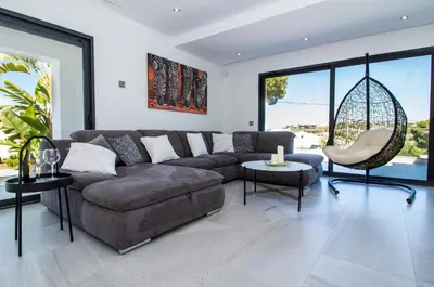 a living room with a couch and a chair at Villa Videira By Dalma Portuguesa - By Dalma Portuguesa in Albufeira
