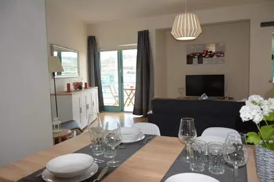 a dining room with a table with plates and wine glasses at Wonderful Apartment Albufeira Marina 4B 2B in Albufeira