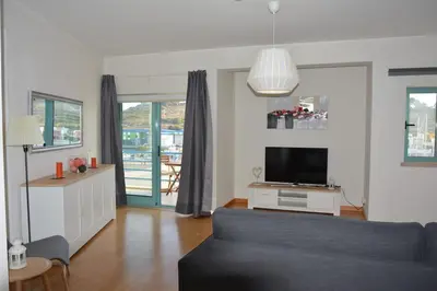 a living room with a couch and a tv at Wonderful Apartment Albufeira Marina 4B 2B in Albufeira