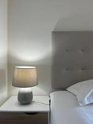 a lamp on a night stand next to a bed at Wonderful Apartment Albufeira Marina 4B 2B in Albufeira