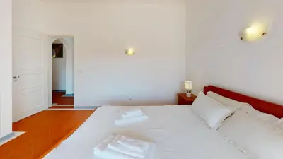 a bedroom with a white bed with two towels on it at Apartamento Tranquilo T1 Albufeira 002 in Albufeira