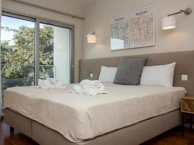 a bedroom with a large bed with towels on it at Green 2 Apartment by Stay ici Algarve Holiday Rental in Albufeira
