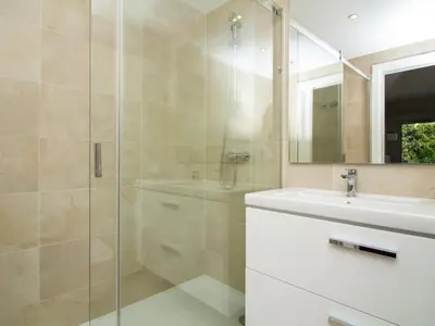a bathroom with a shower and a sink and a mirror at Green 2 Apartment by Stay ici Algarve Holiday Rental in Albufeira