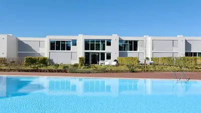 a building with a swimming pool in front of a building at Vila Leonor - Clever Details , Central Vilamoura, Sleeps 6, luxury, walking distance in Vilamoura