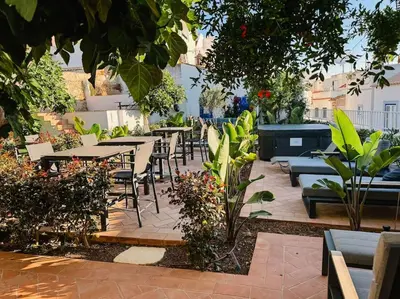 an outdoor patio with tables and chairs and plants at Old Fisherman's Corner 16 - Centro Old Town Albufeira in Albufeira