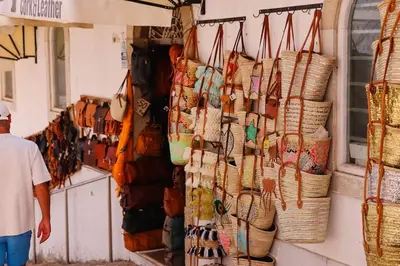 a man standing in a store with baskets on the wall at Old Fisherman's Corner 16 - Centro Old Town Albufeira in Albufeira