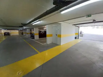 an empty parking garage with a yellow and white parking lot at T3 Alto Forte -Vista Mar,Ar Condicionado,Garagem in Quarteira