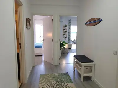 a hallway with a living room with a table at T1 BOAVISTA 6 VISTA MAR Wi-Fi Ar Cond in Quarteira