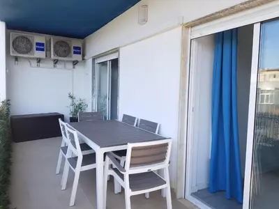 a dining room table and chairs on a balcony at T1 BOAVISTA 6 VISTA MAR Wi-Fi Ar Cond in Quarteira