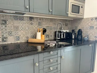 a kitchen with a sink and a counter top at Old Fisherman's Corner 5 - Centro Old Town Albufeira in Albufeira