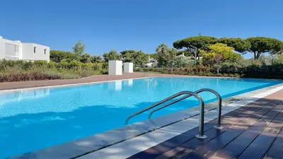 a swimming pool with blue water in a house at Villa Emilia - Clever Details , Central Vilamoura, Sleeps 6, luxury, walking distance in Vilamoura