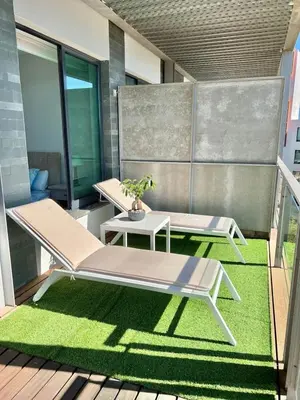 a deck with a table and chairs on a balcony at Superbe appartement spacieux avec terrasse vue piscine in Vilamoura