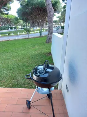 a bbq grill sitting on a brick patio at ALDEIA DAS AÇOTEIAS VILLAGEs in Albufeira