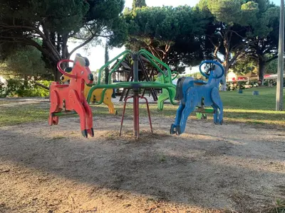 a playground in a park with two swings at ALDEIA DAS AÇOTEIAS VILLAGEs in Albufeira