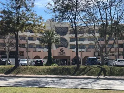 a large building with cars parked in a parking lot at Semanas 30 e 24 Vila Galé Cerro Alagoa in Albufeira