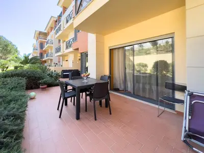 a patio with two chairs and a table with a table at ALBUFEIRA BEACH in Albufeira