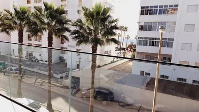 a view of a city from a balcony with palm trees at Apartamento Meerblick in Quarteira
