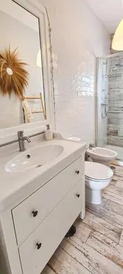 a bathroom with a sink and a toilet and a mirror at Villa O Canto da Parra - Hot Jacuzzi - Swimming Pool - WIFI - BY BEDZY in Galé