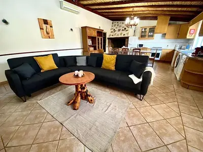 a living room with a blue couch and a table at Palma's Place Casanova Villa #WIFI#HEATEDPOOL#RELAX in Faro