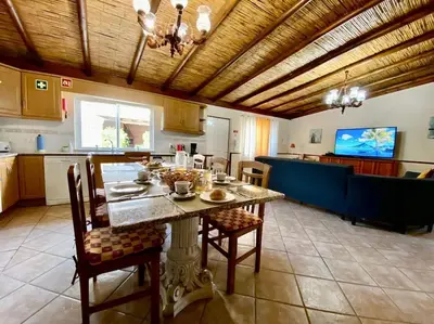 a kitchen with a table and chairs in a room at Palma's Place Casanova Villa #WIFI#HEATEDPOOL#RELAX in Faro