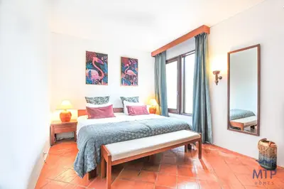 a counter with a bottle of wine and a bowl of oranges at Balaia Beach by MTPhomes in Albufeira
