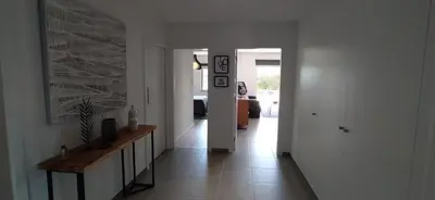 a hallway of a home with white walls and a stone wall at Appartement Standing au coeur d'Albufeira in Albufeira